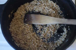 Over low flame, cook rice and spices, stirring to coat rice with oil and allow spices to bloom. 