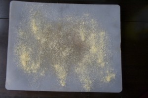 Scatter cornmeal lightly over cutting board.