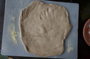 Use a rolling pin and/or hands to roll and press dough into a (sort of) circular shape.