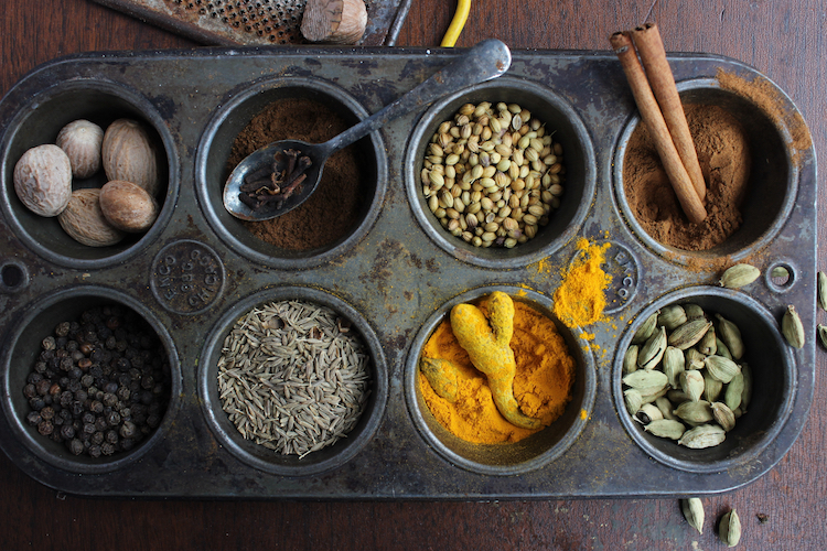 Whole and  ground spices in muffin tin